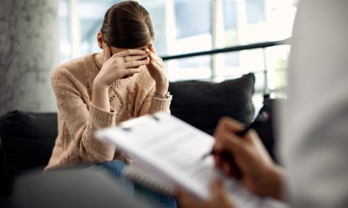 Depressed woman having psychotherapy session at doctor’s office. A women in counselling exploring Why Healing from Past Trauma Is Essential for Healthy Relationships.
