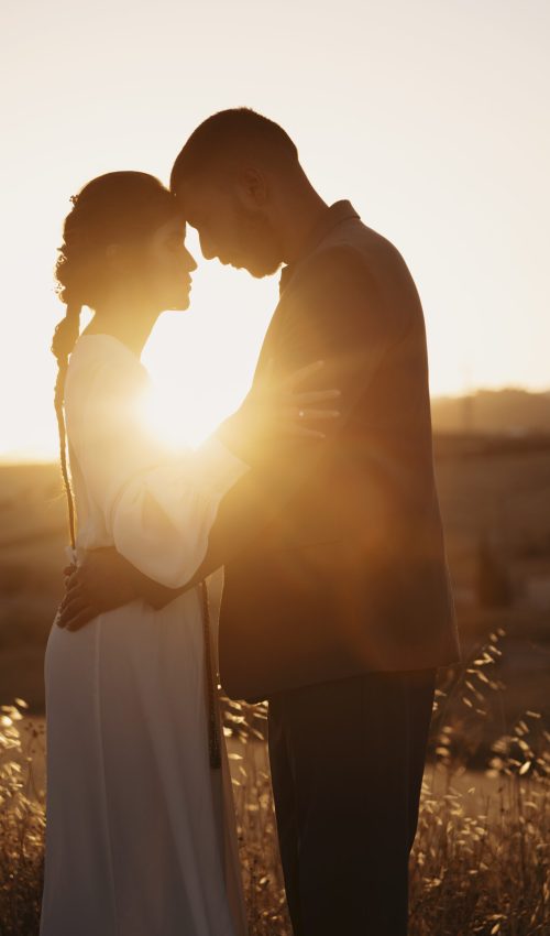 side-view-romantic-couple-outdoors Coloured Couple standing with their heads together in the sunset at their wedding after completing their Pre Marital Counselling Program.